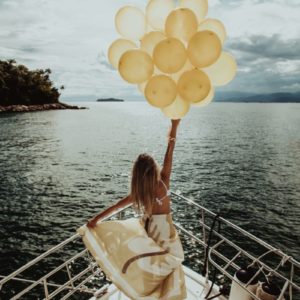 woman with balloons on boat - freedom