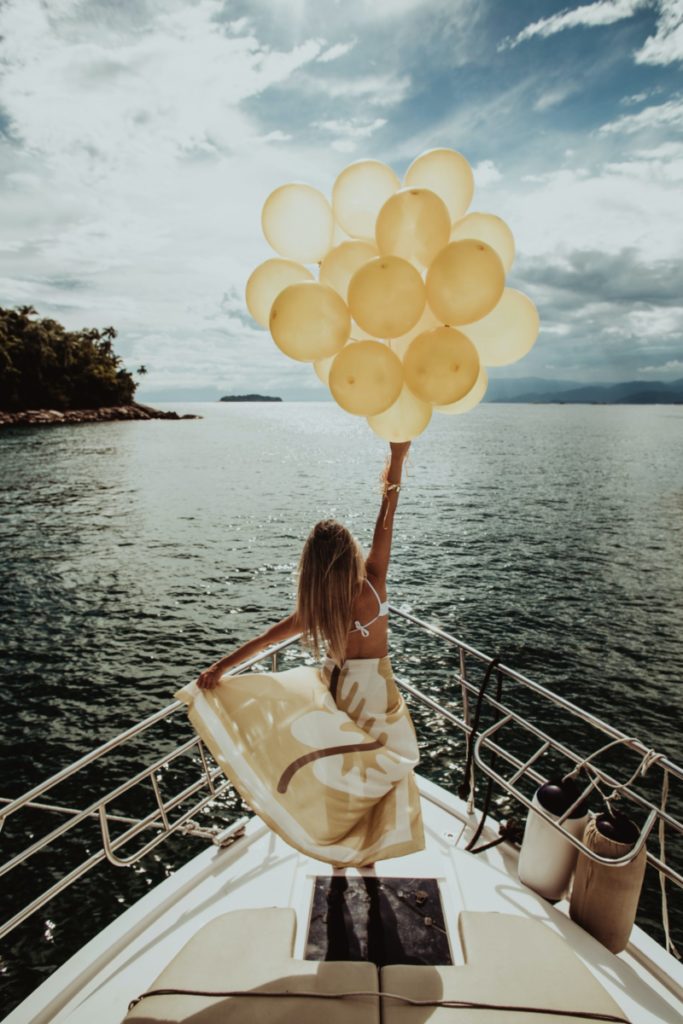 woman with balloons on boat - freedom
